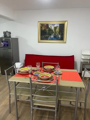 a table with plates and wine glasses on it at Departamentos Alcanfores 775 Miraflores in Lima