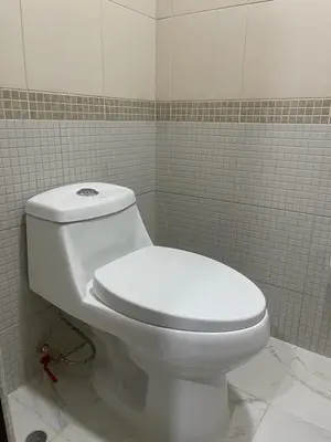 a bathroom with a white toilet in a tiled room at Departamentos Alcanfores 775 Miraflores in Lima