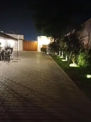 a brick walkway in front of a building at night at Silver Inn Hotel in Cerro Azul