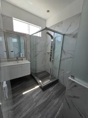 a bathroom with a shower and a sink and a mirror at Silver Inn Hotel in Cerro Azul