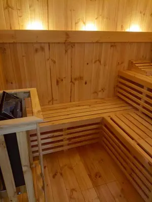 an empty sauna with wooden walls and wooden floors at Silver Inn Hotel in Cerro Azul