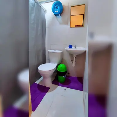 a small bathroom with a toilet and a sink at Antis Apartment in Cusco