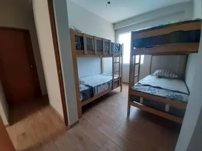 a room with two bunk beds and a hallway at Hermosa Casa de Playa km 90.5 in Bujama Baja