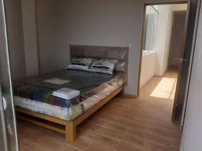 a small bed in a room with a mirror at Hermosa Casa de Playa km 90.5 in Bujama Baja