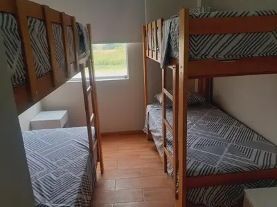 a small room with two bunk beds and a window at Hermosa Casa de Playa km 90.5 in Bujama Baja