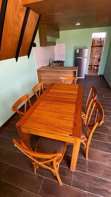 a wooden table with two chairs and a counter at AMAY in Asia