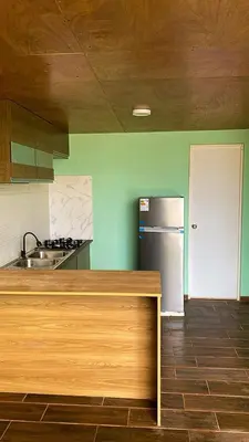a kitchen with a counter top and a refrigerator at AMAY in Asia