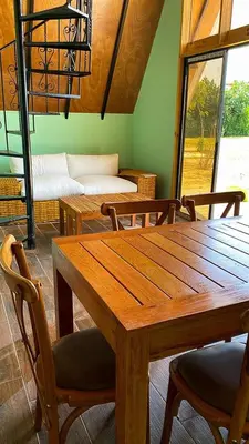 a dining room with a wooden table and chairs at AMAY in Asia