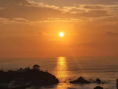 a sunset over the ocean with the sun in the sky at ALTEA HOTEL - San Bartolo in San Bartolo