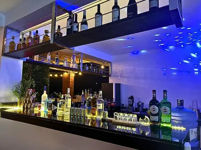 a bar with a lot of bottles of alcohol at ALTEA HOTEL - San Bartolo in San Bartolo