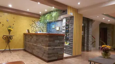 a bar in a lobby with a brick wall at Hotel Pucara Machupicchu in Machu Picchu