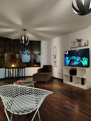 a living room with a couch and a tv at Pacific Spot San Miguel in Lima