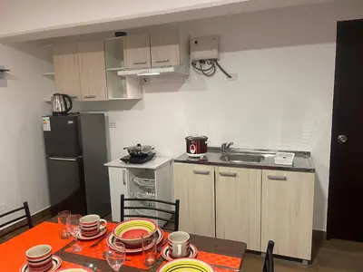 a kitchen with a table with plates on it at 23 Dpto de Estreno Miraflores in Lima