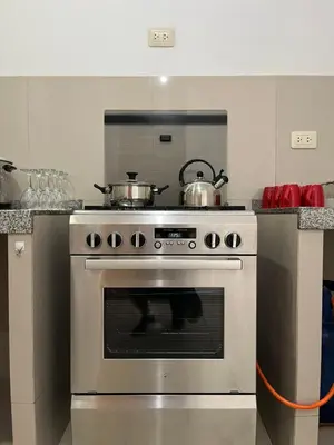 a kitchen with a stove with two pots on it at MH Apartments Ica 2 in Ica