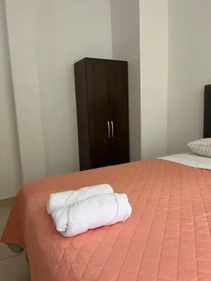 a bedroom with two white towels on a bed at MH Apartments Ica 2 in Ica