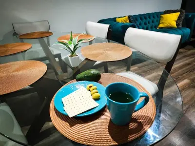 a glass table with a keyboard and a cup of coffee at San Miguel Exclusivo Depa Vista al Mar, piscina in Lima