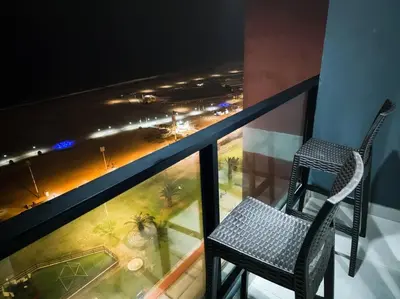 a chair on a balcony with a view of a city at San Miguel Exclusivo Depa Vista al Mar, piscina in Lima