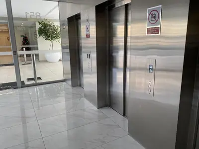 a row of elevators in a lobby of a building at Moderno departamento Miraflores 360 in Lima