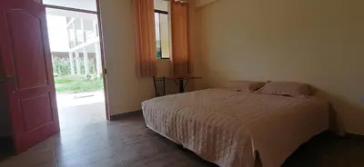 a bedroom with a bed and a large window at Catalina Huanca Resort in San Jerónimo