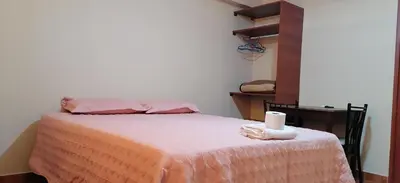 a bedroom with a bed with a candle on it at Catalina Huanca Resort in San Jerónimo