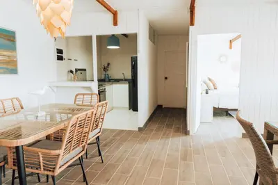 a kitchen and dining room with a table and chairs at Atenas Hotel Boutique in Paracas
