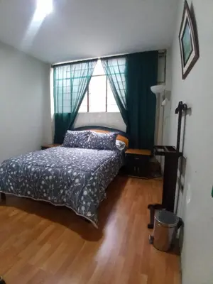 a bedroom with a bed and a window at Mochileros in Lima