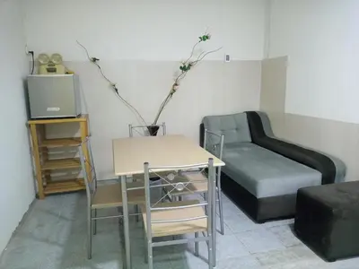 a living room with a bed and a table and a couch at Mochileros in Lima