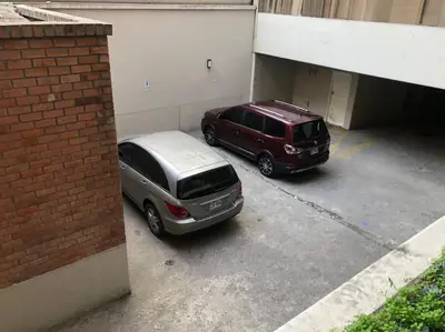 two cars are parked in a parking lot at (28) Acogedor dpto. Miraflores in Lima
