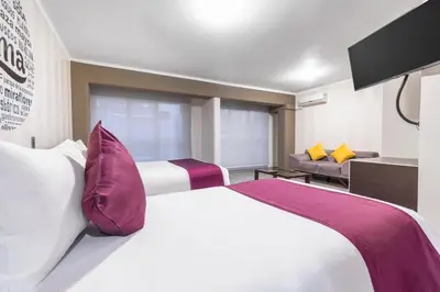 a hotel room with a bed and a tv at Hotel Andesmar in Lima
