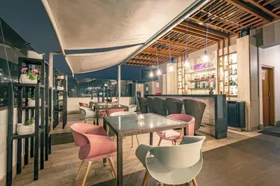a restaurant with pink chairs and a table at Hotel Andesmar in Lima