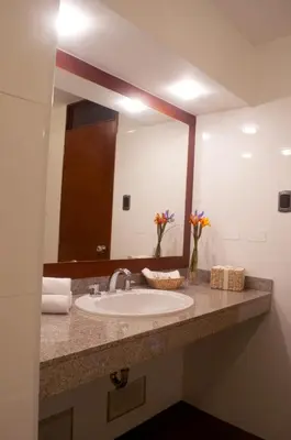 a bathroom with a sink and a large mirror at Hotel Andesmar in Lima
