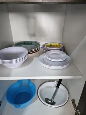 a shelf with plates and bowls in a refrigerator at Dpto acogedor con terraza privada in Lima