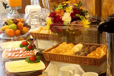a buffet with many different types of food on a table at El Polo Hotel & Suites in Lima