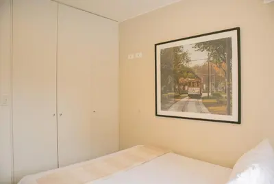 a bedroom with a painting on the wall and a bed at Cantuarias 355 by Wynwood House in Lima
