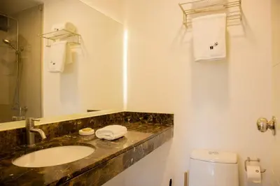 a bathroom with a sink and a toilet at Cantuarias 355 by Wynwood House in Lima