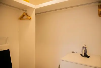 a bathroom with a white wall and a toilet at Cantuarias 355 by Wynwood House in Lima