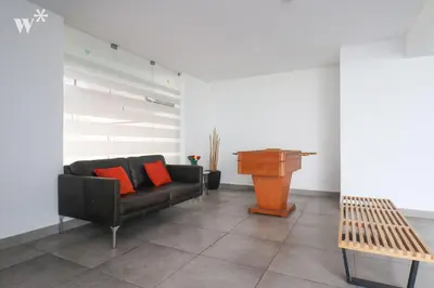 a living room with a couch and a piano at Cantuarias 355 by Wynwood House in Lima