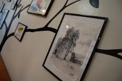 a picture of a picture of a clock tower on a wall at Casa Antade Cusco in Cusco
