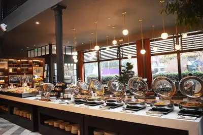 a buffet line with plates of food in a store at DoubleTree by Hilton Lima Miraflores El Pardo in Lima