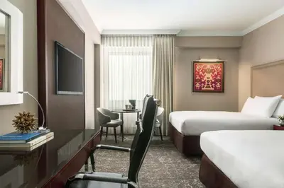 a hotel room with two beds and a desk at DoubleTree by Hilton Lima Miraflores El Pardo in Lima