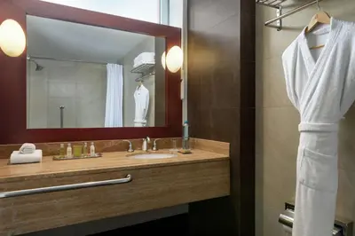 a bathroom with a sink and a mirror at DoubleTree by Hilton Lima Miraflores El Pardo in Lima