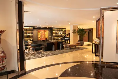 a lobby with a library with a desk and chairs at DoubleTree by Hilton Lima Miraflores El Pardo in Lima