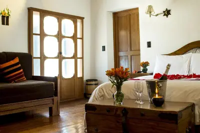 a bedroom with a bed and a table with flowers on it at Casa San Blas Cusco Boutique Hotel in Cusco