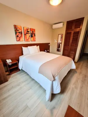 a bedroom with a large white bed in a room at Hotel Las Palmas in Lima