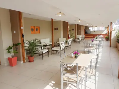 a row of tables and chairs in a cafeteria at Hotel Las Palmas in Lima