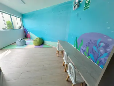 a classroom with a table and an aquarium mural at Departamento exclusivo con vista al mar in Lima