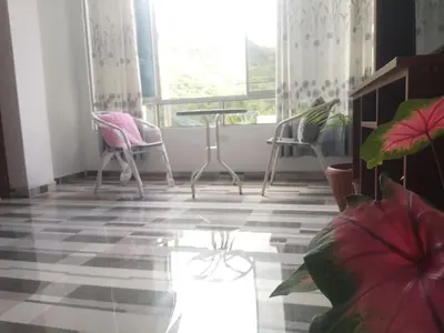 a room with chairs and a table and a window at Mi Chanchamayo, family. in La Merced