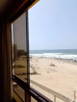 a view of the beach from a window at Arica Surf & Beach House in Arica