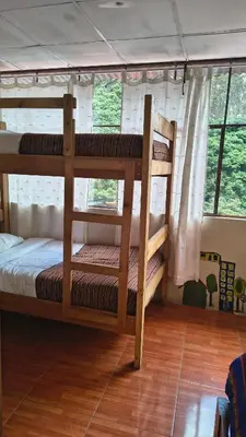 two bunk beds in a room with a wooden floor at ECO ART Best view Machu Picchu in Machu Picchu