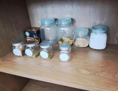 a shelf with jars of food and other ingredients at VK Loft - Apartamento en Miraflores in Lima